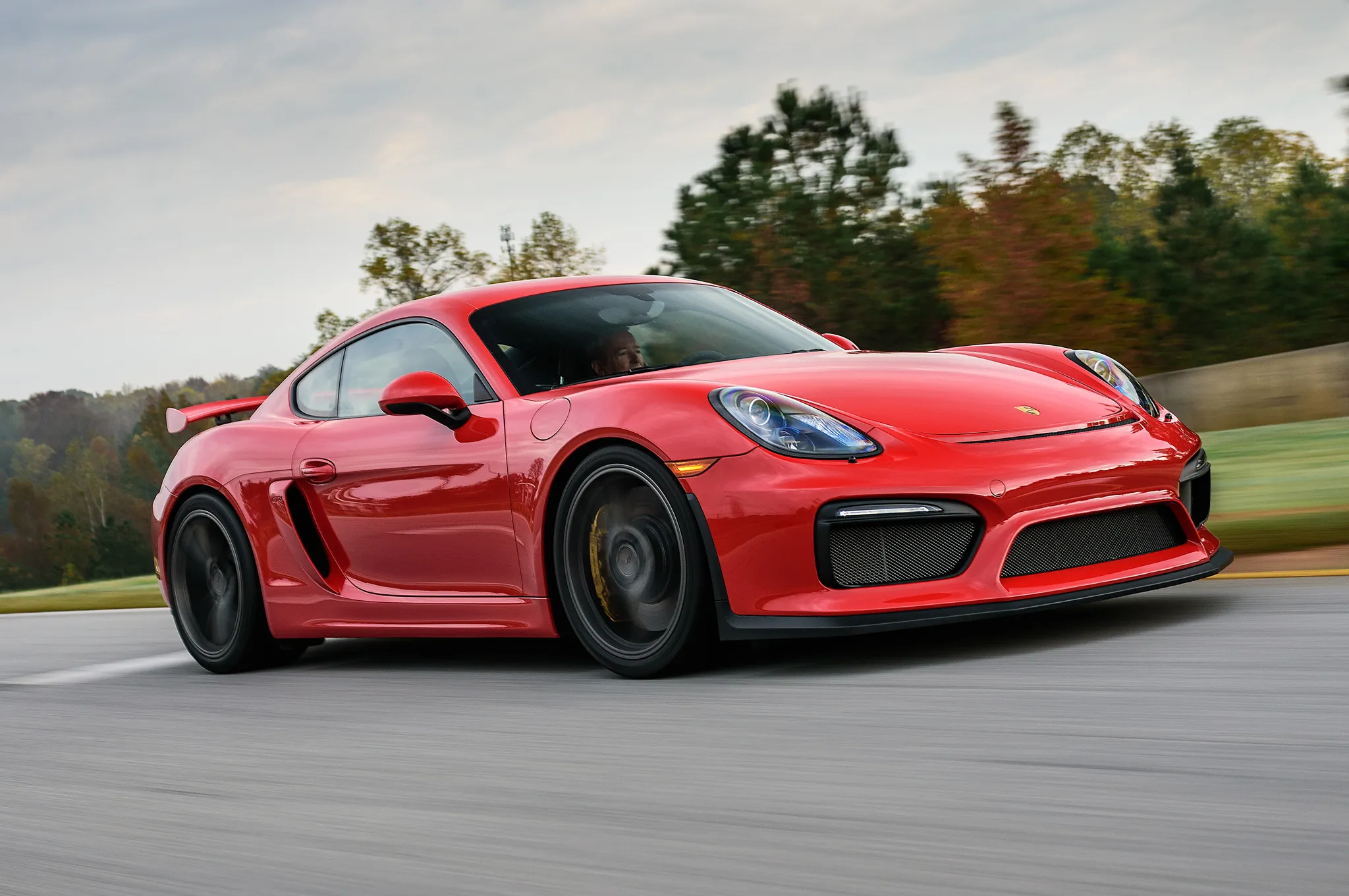 A 2016 Porsche Cayman GT4 981 on the track at Road Atlanta, showcasing its reputation as an exceptional driver's car with a 350 hp flat-six engine, a highly sought-after sports car for under 0k.