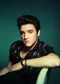 A black and white portrait of a young Elvis Presley, showcasing his captivating stage presence and raw talent.