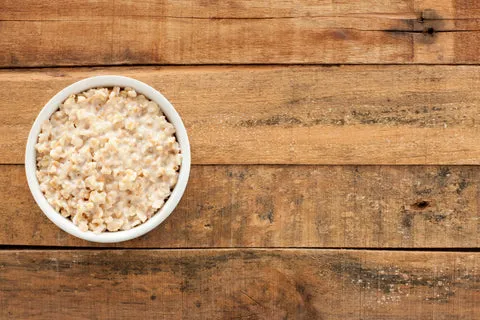 A bowl of oatmeal on a wooden table