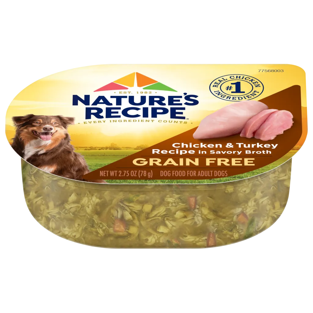 A bowl of wet dog food with visible chunks of meat and vegetables