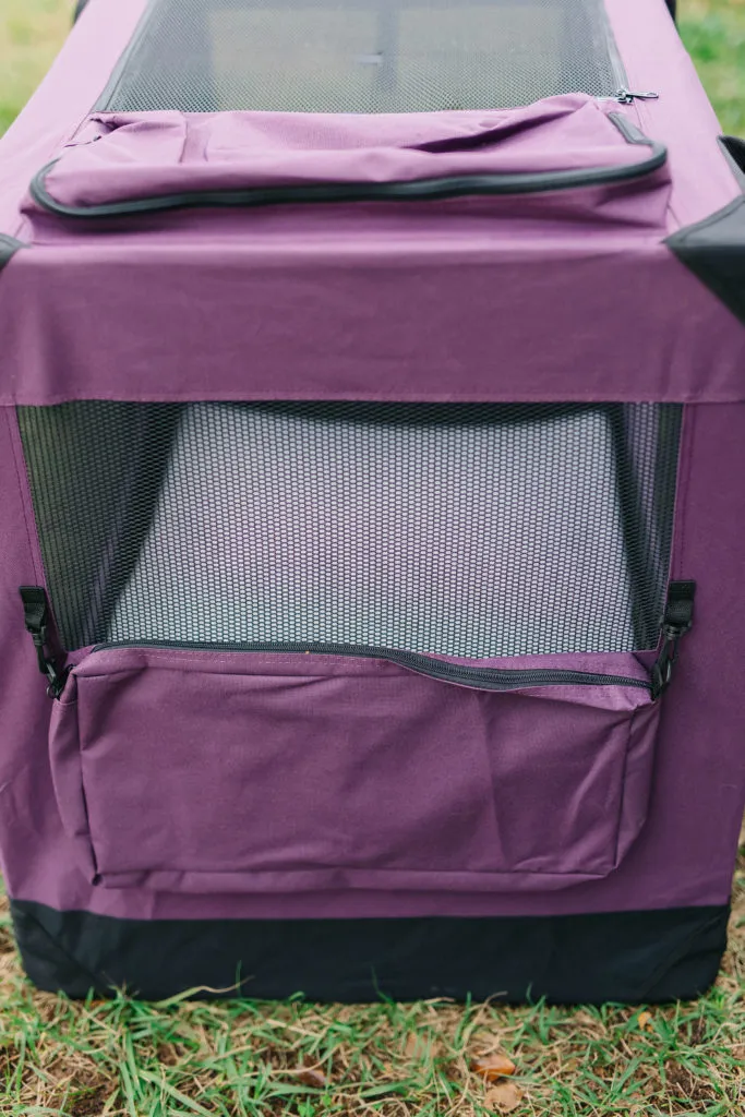 A close-up of a soft sided dog crate's storage pocket, featuring a zipper closure and ample space for small pet items.