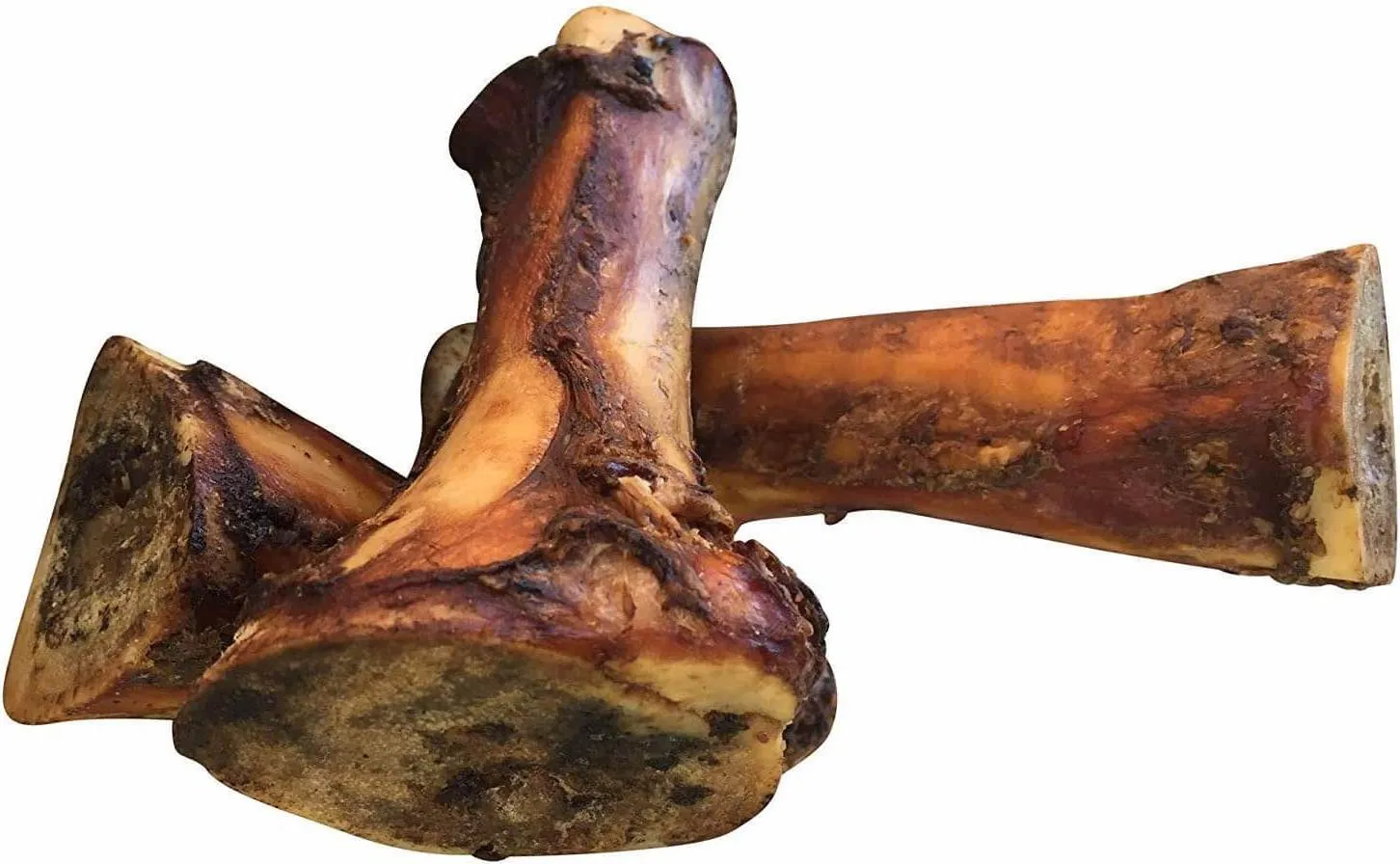 A close-up of several K9 Connoisseur natural marrow bones, rich in color, displayed on a wooden surface, highlighting their meaty texture.