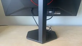 A close-up of the AOC Gaming Q27G4ZR monitor's base, highlighting its robust design and subtle gaming accents