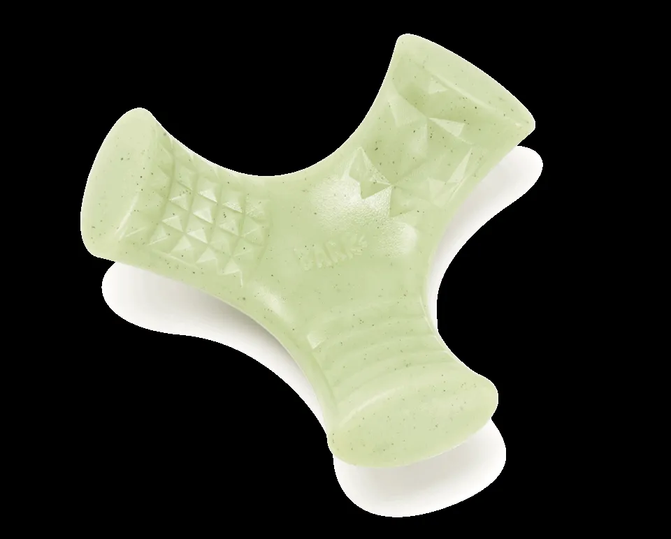 A dog chewing on a Super Chewer "Chopper" dental toy, designed for plaque removal and fresh breath.