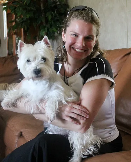 A joyful West Highland White Terrier playing outdoors