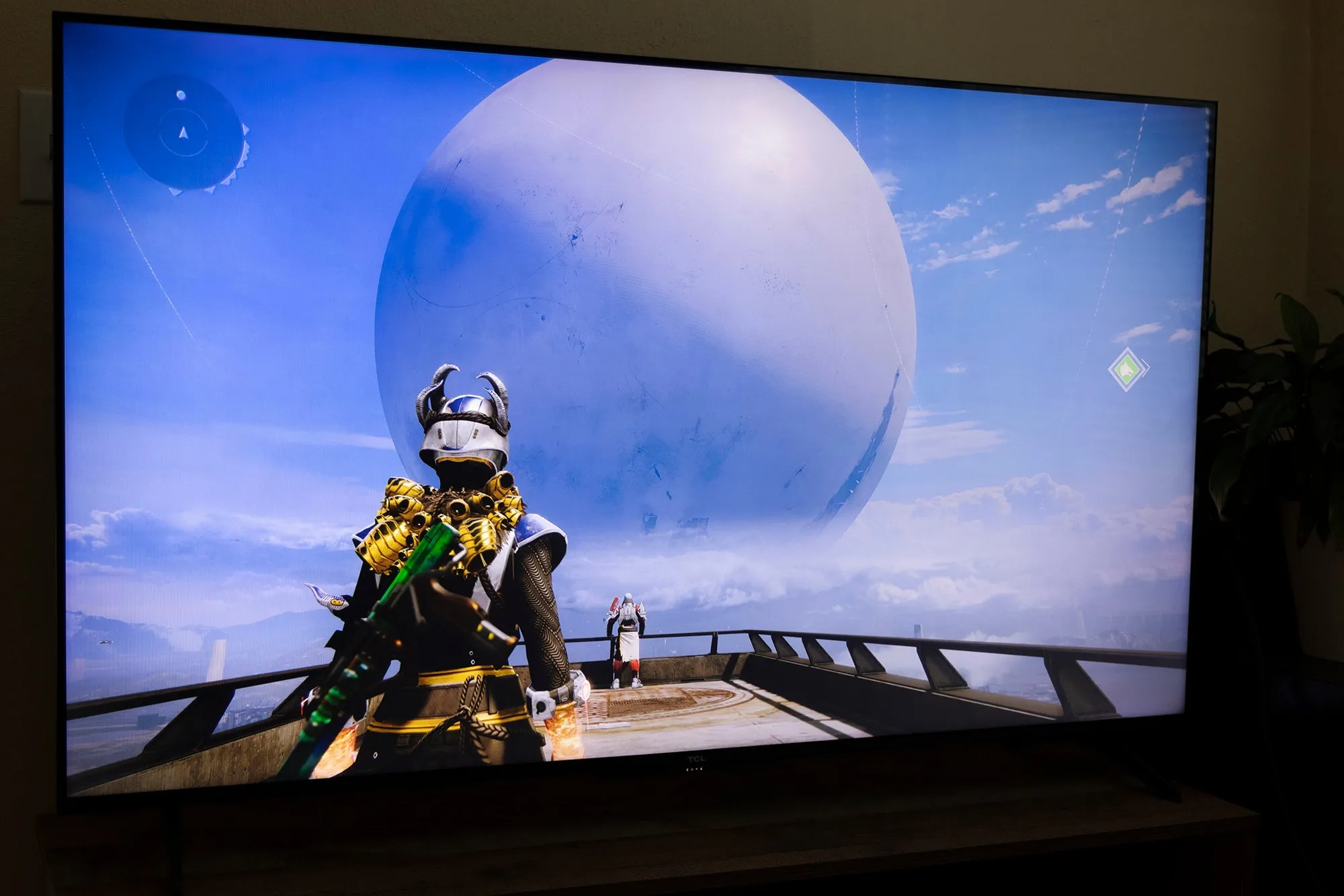 A living room setup showcasing a large TV used for gaming, highlighting the immersive experience on a comfortable couch.