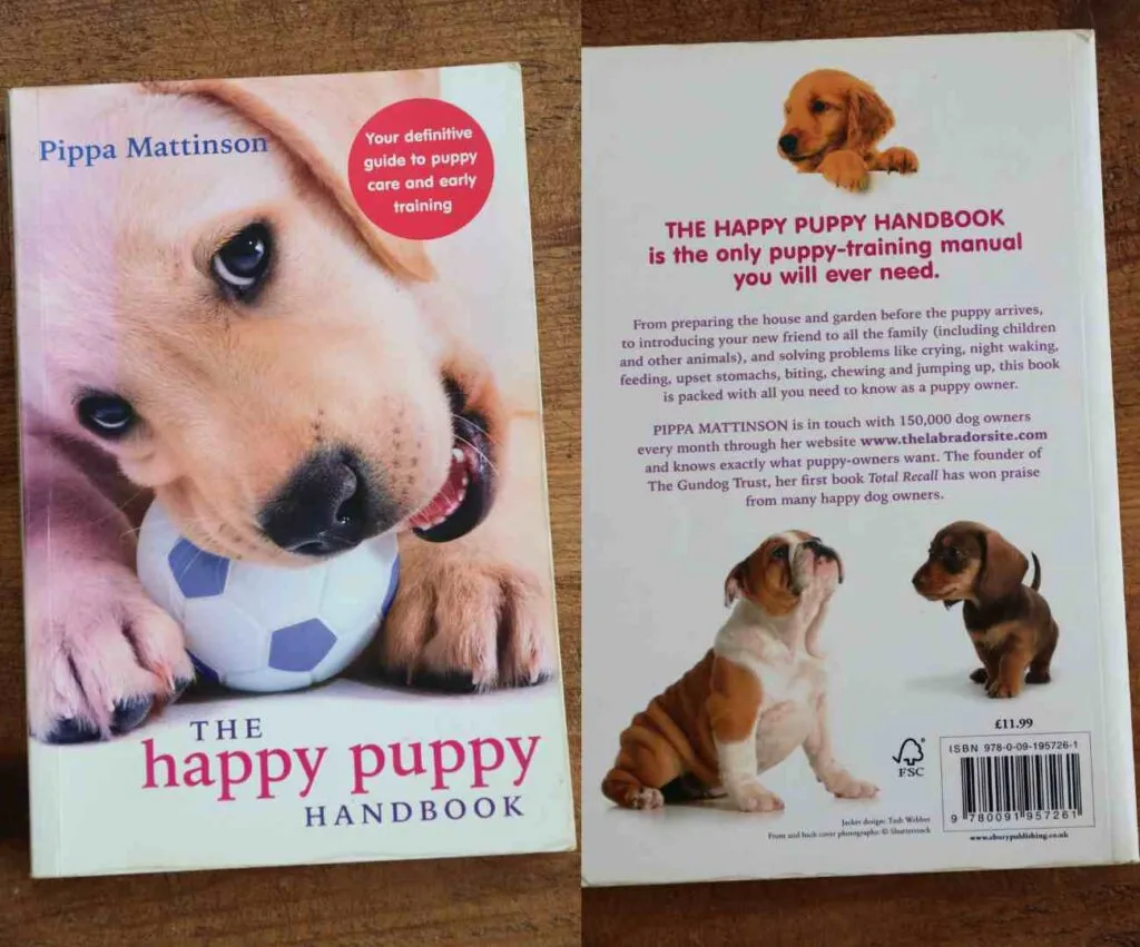 A pile of puppy training books on a table
