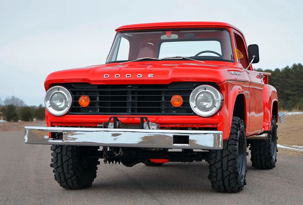 A rugged 1967 Dodge W100 Power Wagon 4x4 featuring the classic Utiline (stepside) bed and a fresh refinished oak wood bed, highlighting the utility of vintage Dodge trucks