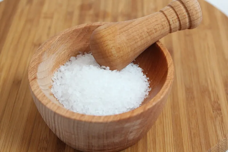 A salt shaker with spilled salt, representing the dangers of excessive sodium for dogs.