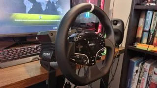 A side angle of the MOZA R5 wheelbase mounted to a desk