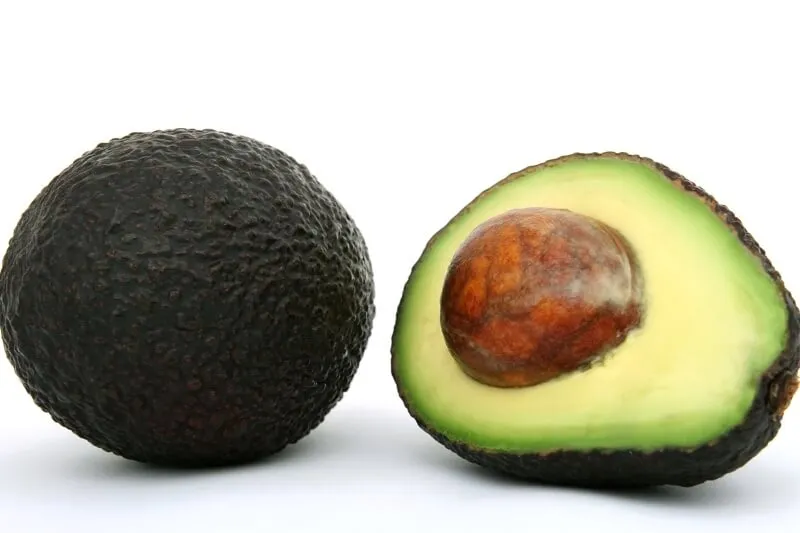 A sliced avocado, highlighting the dangerous persin compound for dogs.