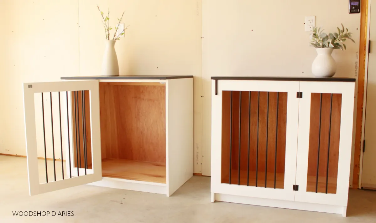 A stylish black and white wooden dog crate cabinet with one door ajar, showcasing its design and functionality