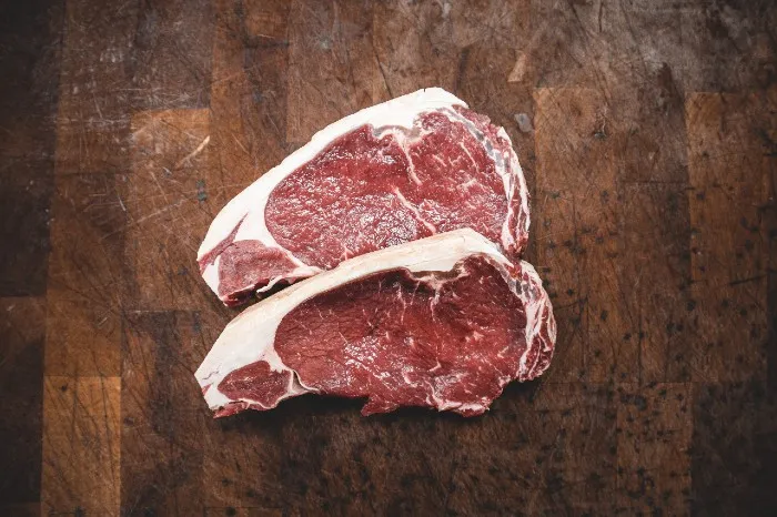 A variety of raw and cooked meats suitable for dogs, including chicken, beef, and fish, highlighting different protein sources for a healthy canine diet.
