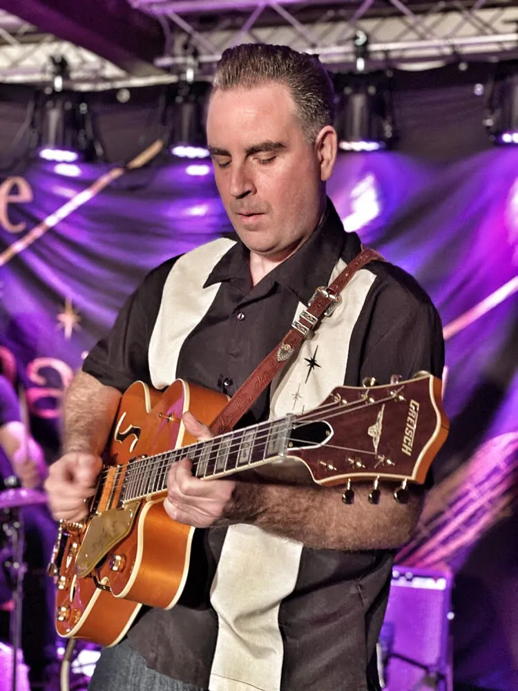 A vintage-inspired Gretsch 6120 55VS electric guitar, favored by musicians for its classic chuck berry gretsch sound.