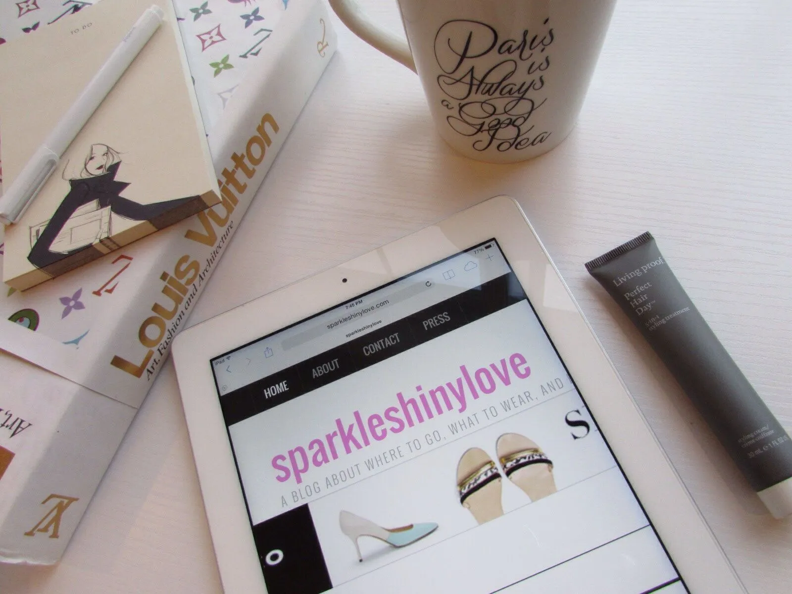 A visually appealing arrangement of the Living Proof styling product bottle with hair strands