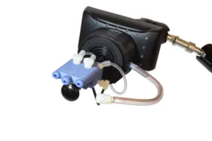 A white plastic video game controller with clear plastic tubes and a mouthpiece attached for puff and sip inputs.