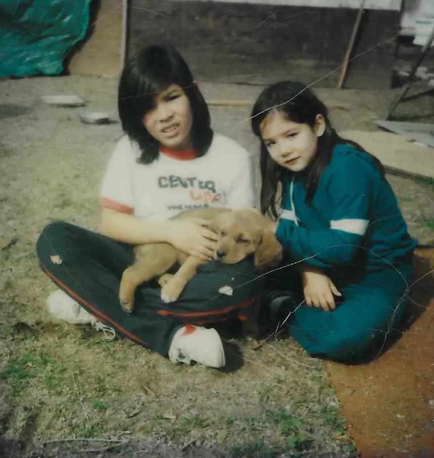 A young Jennifer Li Shotz with her brother and their dog, Mork, capturing a nostalgic childhood memory.