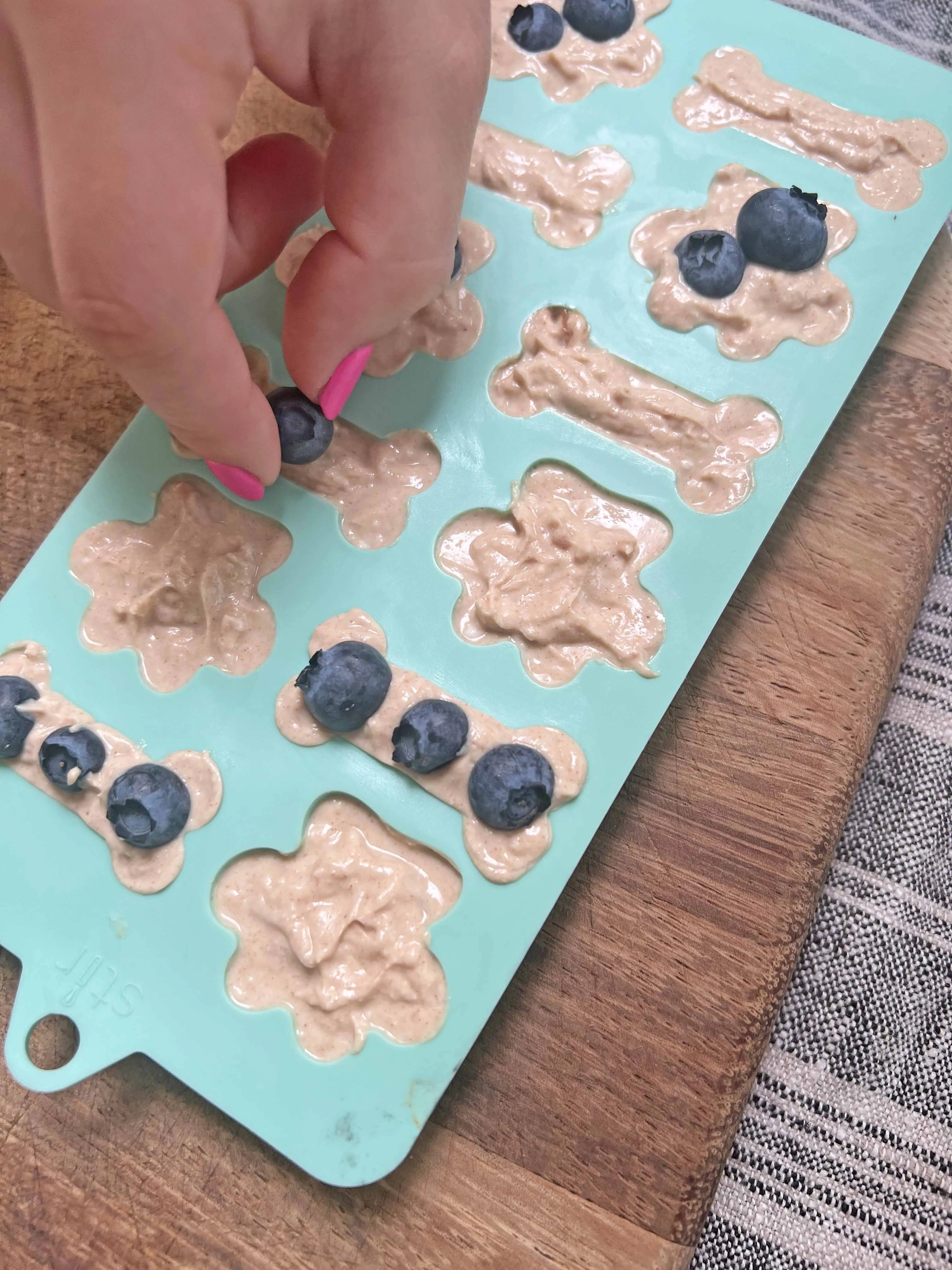 Adding blueberries to the dog treats