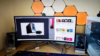 An AOC AGON PD34 ultrawide monitor on a desk, showcasing its sleek curved design for an immersive workspace