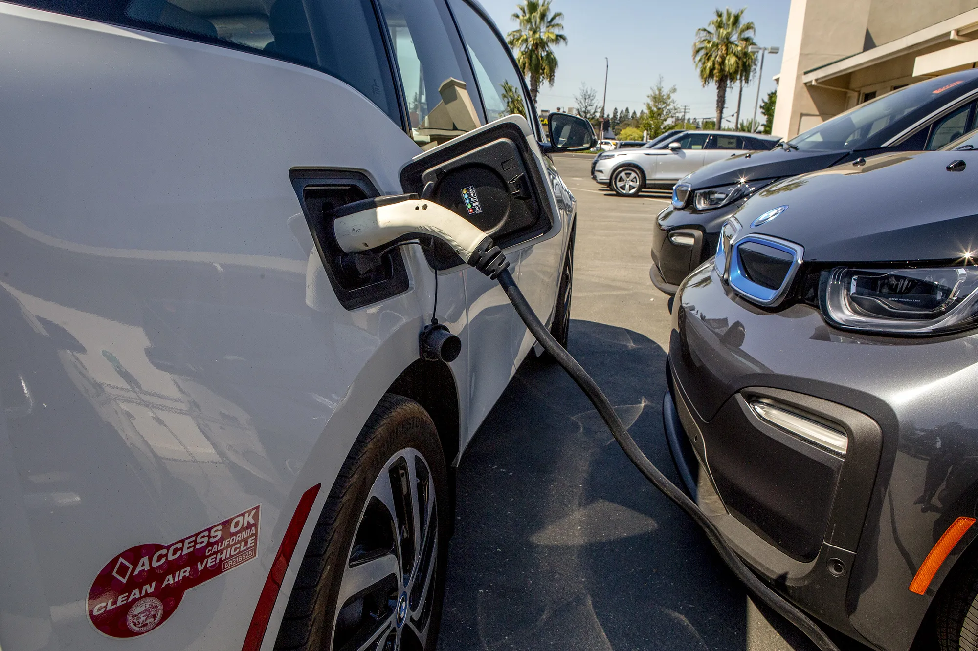 An electric vehicle charging at a charging station