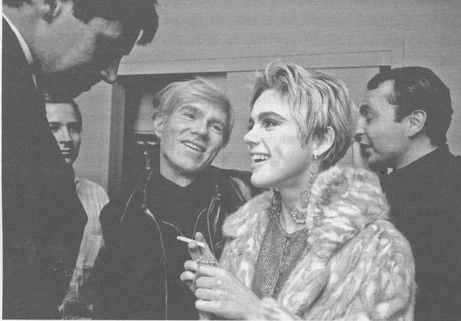 Andy Warhol and Edie Sedgwick sharing a moment at The Factory, reflecting their intense but fleeting connection in 1965