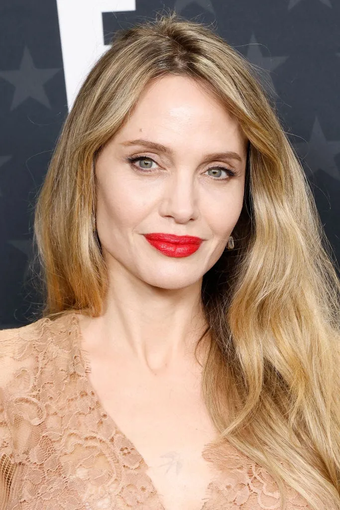 Angelina Jolie showcasing her blonder hair from earlier this year, contrasting with her iconic raven brunette shade from her younger days