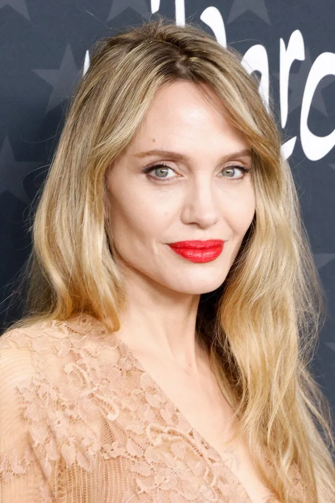 Angelina Jolie with a more defined makeup style, featuring her signature smokey eye and a fuller lip