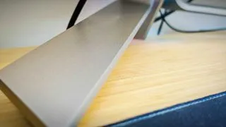 AOC AGON PD34 monitor from a side view, emphasizing its thin profile despite the large curved screen