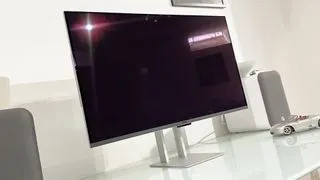 Asus ProArt PA32UCDM monitor showcasing its flexible stand and the ability to tilt and swivel for ergonomic comfort