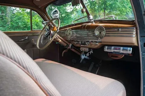 Beige interior of the 1941 Chevrolet Special Deluxe Coupe featuring a wood-grain dashboard and classic steering wheel.