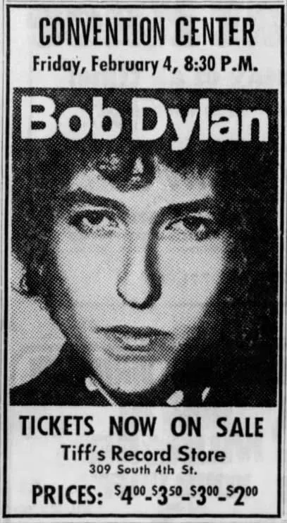 Bob Dylan performing live on stage in 1966 with his electric guitar