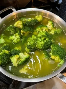 Broccoli florets being boiled until tender.