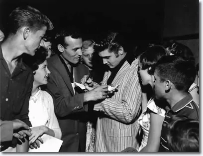 Carl Perkins and Elvis Presley together backstage, swapping autographs in Memphis 1956