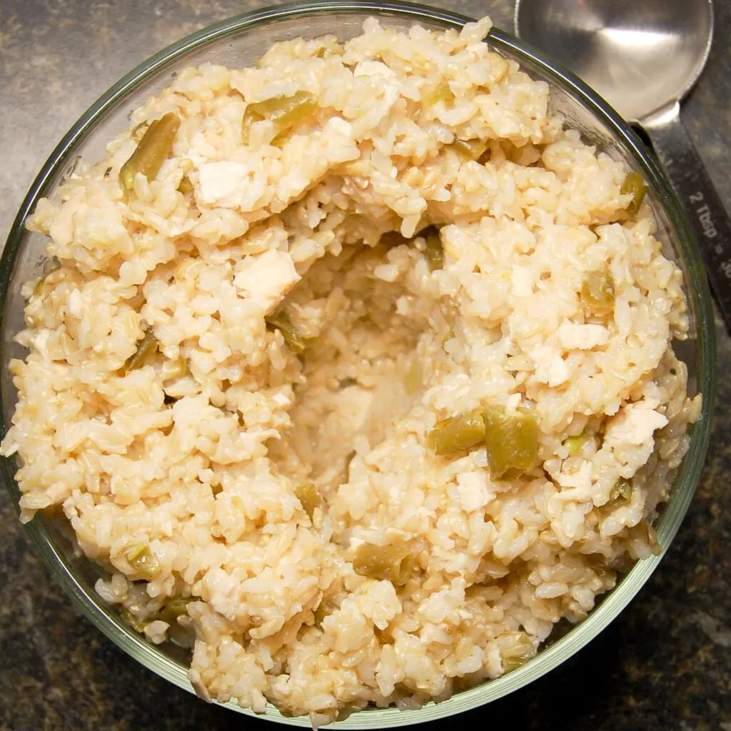 Chicken and rice in a glass bowl with a crater for faster cooling