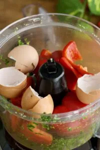 Chopped vegetables and liver in a food processor