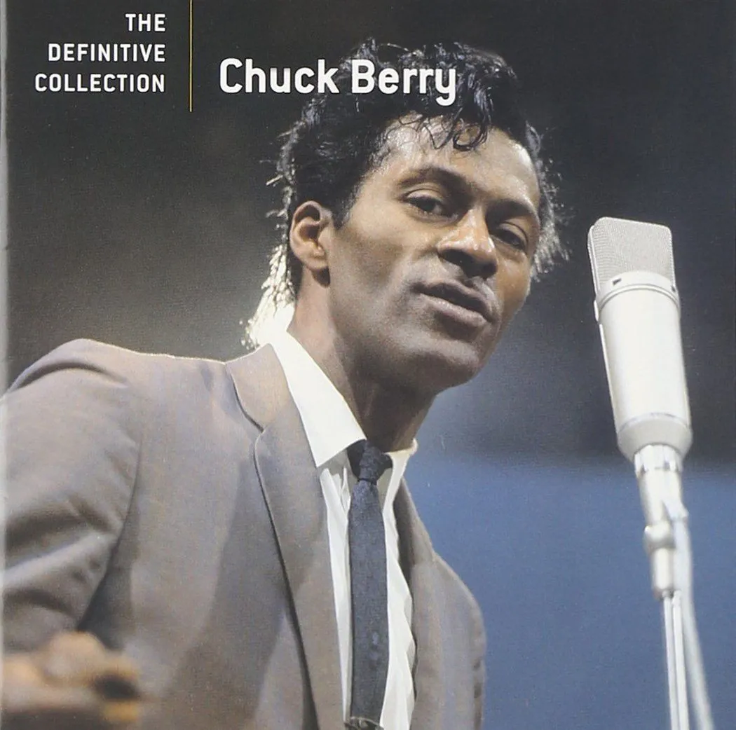 Chuck Berry performing live with his electric guitar, iconic rock and roll pose