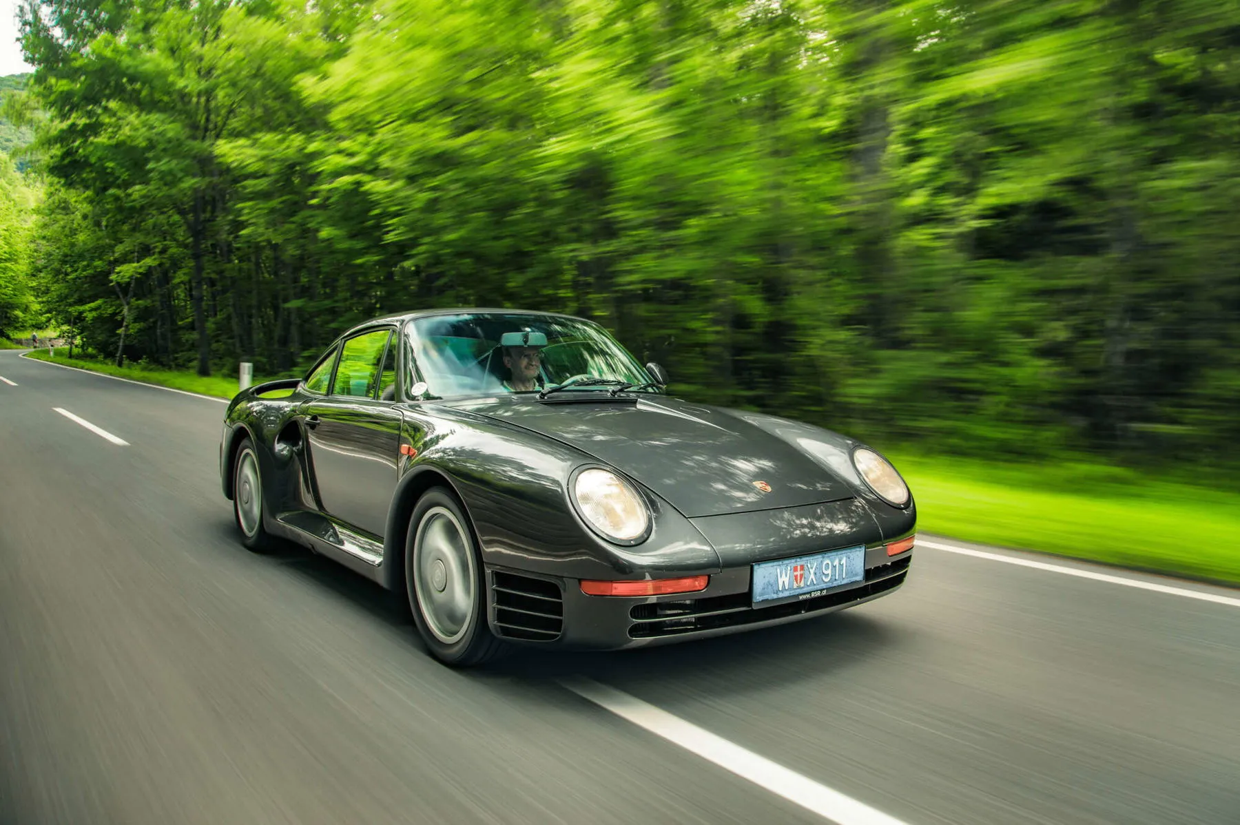 Classic red Porsche 959 super sports car parked, a rare collectible