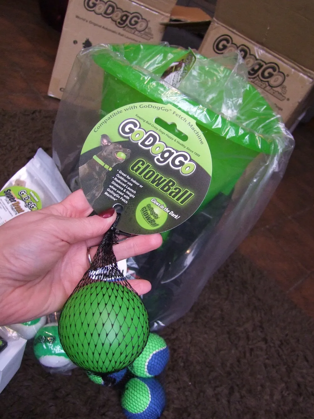 Close-up of a GoDogGo automatic dog ball thrower filled with an assortment of colourful tennis balls