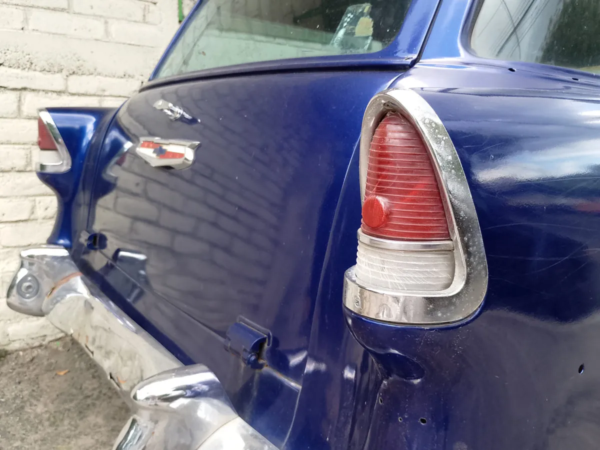 Close up of the driver side door of a 1955 Chevrolet wagon showing the missing trim