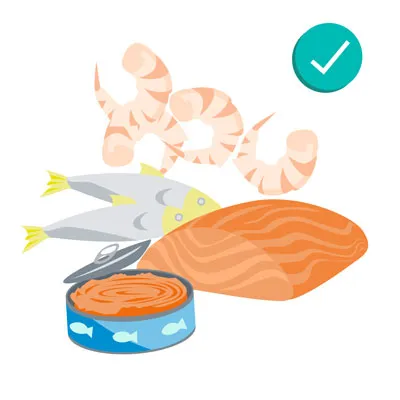 Cooked shrimp and whole fish, signifying safe and healthy seafood choices for dogs when prepared correctly.