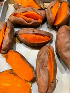 Cooked sweet potatoes, an excellent source of dietary fiber and beta-carotene for healthy homemade dog food, shown in a bowl.