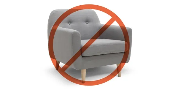 Damaged furniture by a dog, indicating destructive chewing behavior often linked to anxiety or boredom