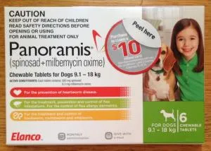 Dog looking at a Panoramis (now Comfortis Plus) package