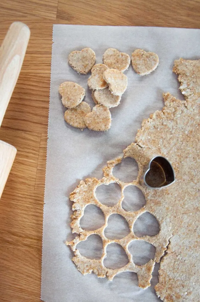 Dog treats being cut out with a cookie cutter
