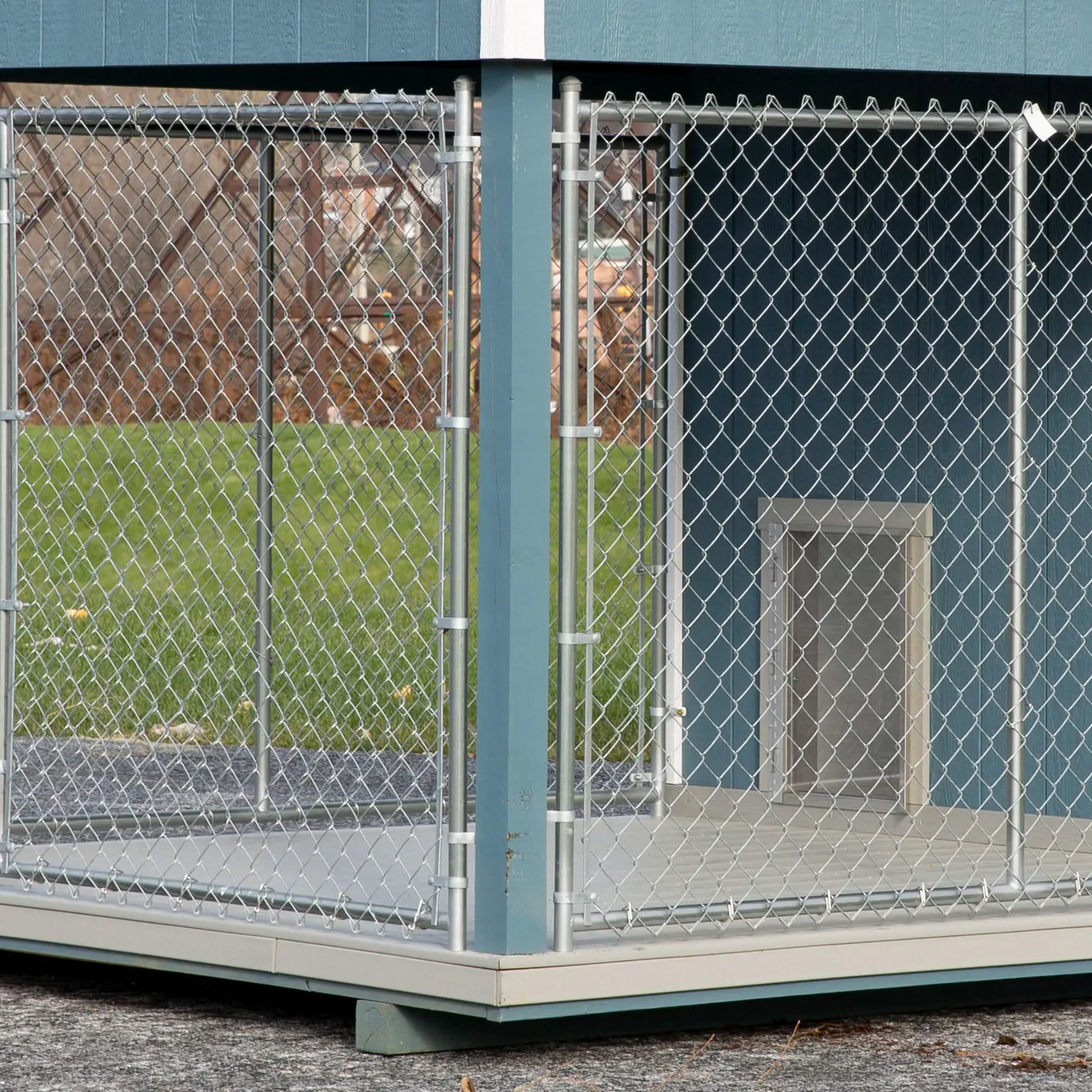 Durable chain-link dog run with poly decking in a large outdoor dog kennel