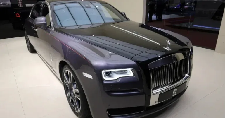 Elegant Rolls-Royce Ghost Elegance, showcasing the world's first diamond-infused paint finish, "Diamond Stardust," shimmering under sunlight.