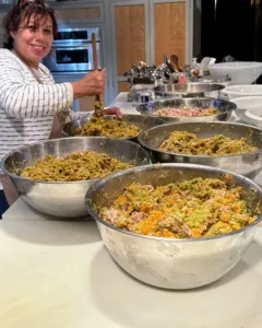 Elvira Rojas mixes processed homemade dog food before packaging.