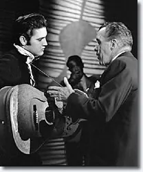 Elvis Presley and Ed Sullivan conversing backstage