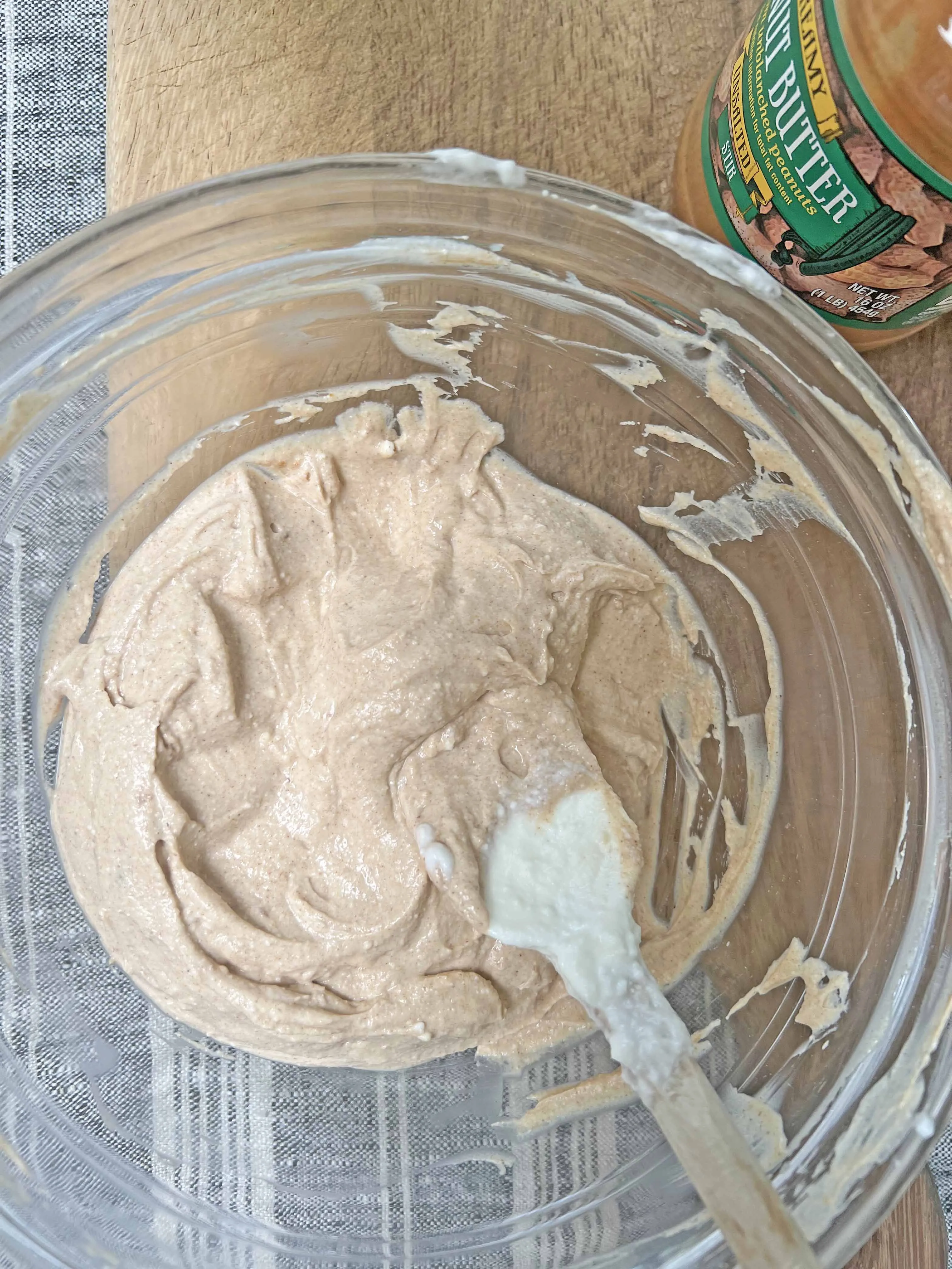 Filling paw and bone-shaped silicone molds with the dog treat mixture