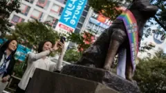 Getty Images A lesbian couple take a photo of the Hachiko statue